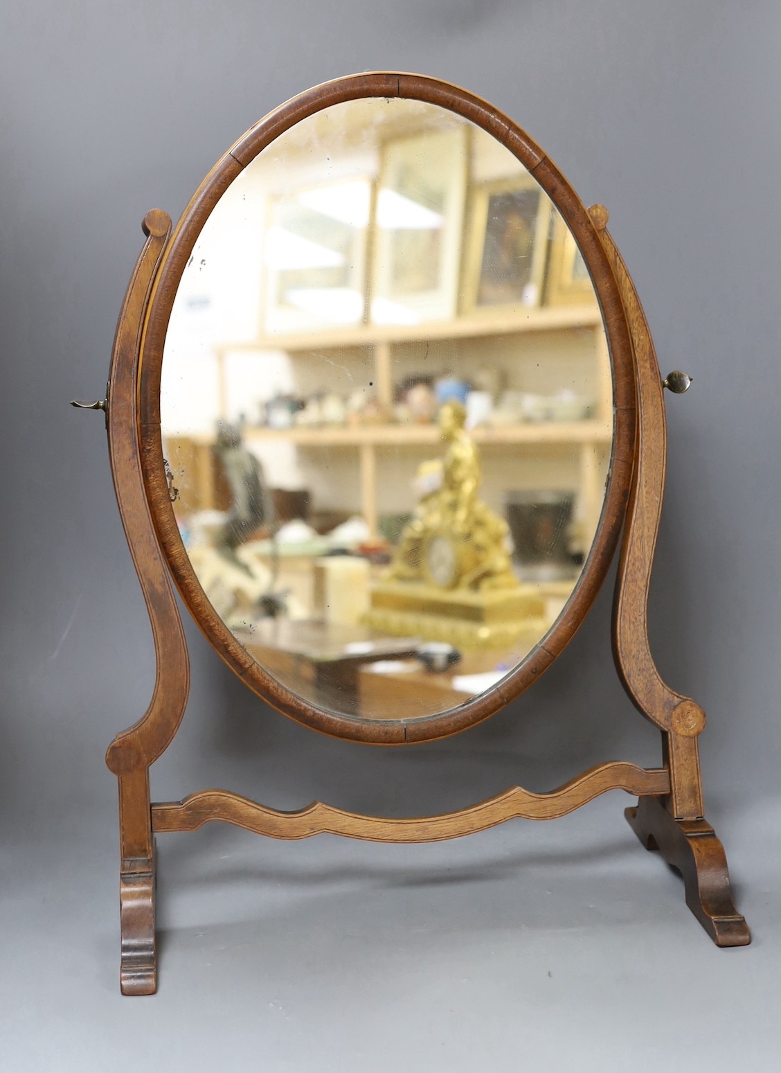 A swing mahogany frame toilet mirror with satinwood banding, 53cm tall